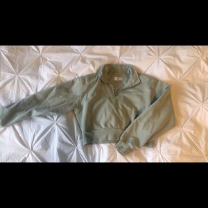 TNA cropped quarter zip in light green/ sage green.